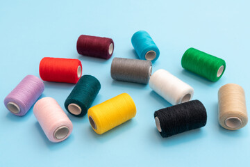 Closeup isometric view of scattered colored spools of sewing threads