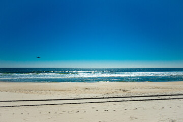 small plane flying over atlantic coast