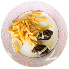 main course for dinner is fried grilled fatty blood sausage black pudding with bow and slices of...