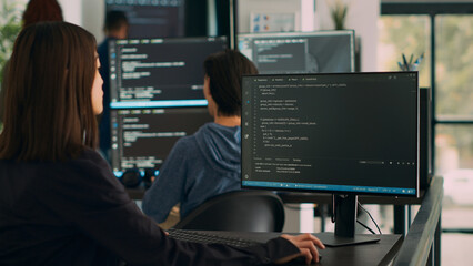 Database programer writing source code on terminal window with html script, working on software...