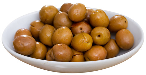 Naklejka na ściany i meble Bowl with shiny slightly cracked green olives with pits. Isolated over white background
