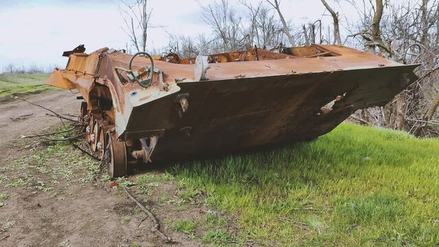 Russian tank or bmp destroyed by the Ukrainian military during the invasion of Ukraine. The remains of a blown up Russian tank in the Kherson region, Ukraine . The tank is covered with rust