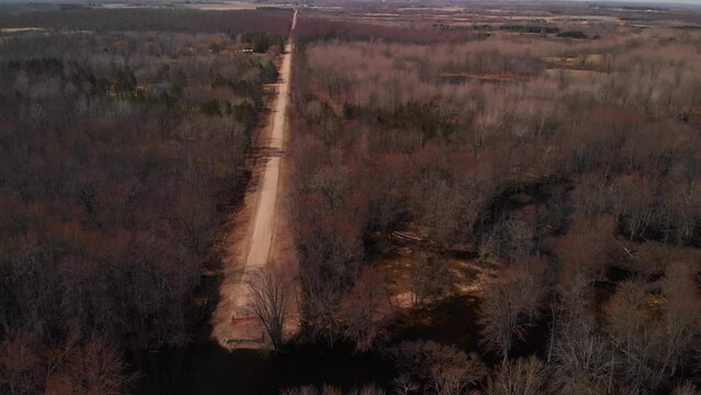 Aerial of Dirt Road and Bridge out in Springtime in Michigan, USA.