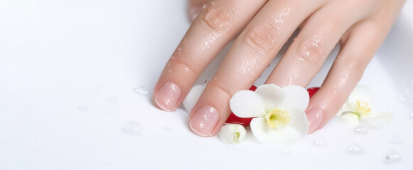 Spa treatment and product for female feet and hand spa, Thailand. Classic white wedding nail manicure with flowers. Spa treatment concept. Natural hygiene.