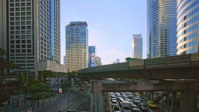Sunny day in business downtown, light train rails and skyscrapers. 