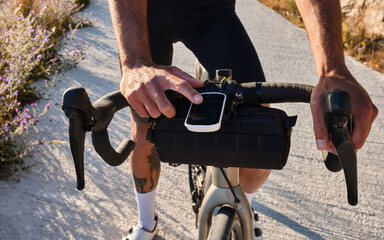A cyclist using a bike computer close-up photo.
