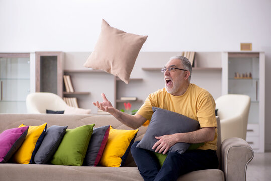 Old man with many pillows at home - Powered by Adobe