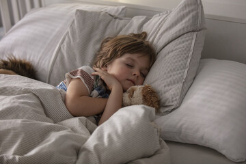 Little boy sleeping in bed. In the morning, the toddler sleeps in his room. Lifestyle.
A child's healthy sleep. 
