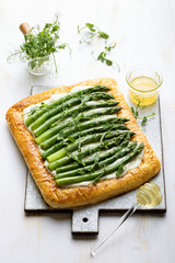 Green asparagus and cream cheese puff pastry tart with pea micro greens and honey. Seasonal spring...