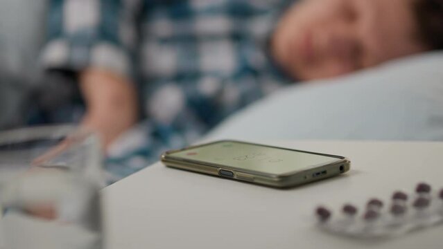 Sleeping, Responsible employee of the company Calmly Looking for how to turn off the smartphone alarm sound In his room, In slow motion Athlete Sleeping Wants to work out in the gym, night
