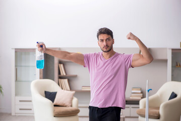 Fototapeta premium Young male contractor cleaning the house