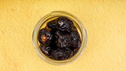 A glass jar filled with typical Arabic dates as a dish during the month of Ramadan