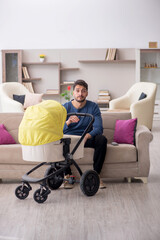 Young man looking after newborn at home