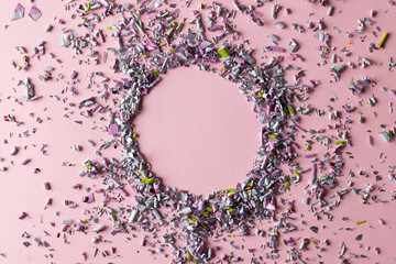 Image of confetti and circle with copy space on pink background