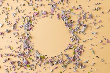Image of confetti and circle with copy space on yellow background