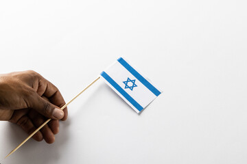 Close up of biracial man holiday flag of israel with copy space on white background