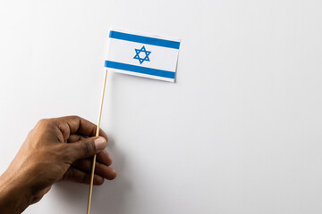 Close up of biracial man holiday flag of israel with copy space on white background