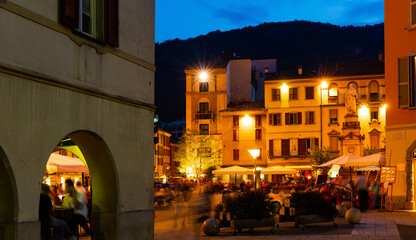 Busy nightlife of illuminated central Como streets in summer, Italy.