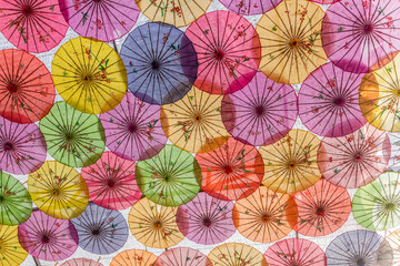 Fototapeta na wymiar Colorful umbrellas covering a courtyard in China
