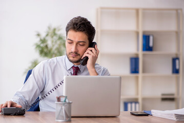 Young male employee working in the office