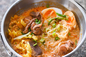 curry bone soup - bone noodle soup pork with boiled eggs in hot pot, Thai food tom yum hot and sour soup