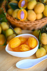 Sweet dessert marian plum fruit  on bowl for food and wooden background, tropical fruit Name in Thailand sweet Yellow Marian Plum Maprang Plango or Mayong chid