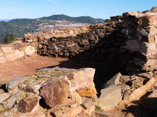 View of remains of antique fortified Iberian settlement at archaeological site of Puig Castellar, near Barcelona, Spain