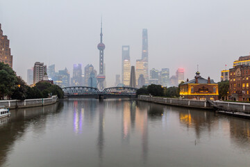 Obraz premium Skyscrapers of Pudong behind historical Waibaidu bridge in Shanghai, China