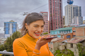 Fototapeta premium Young Latina Woman Enjoying a Joyful Phone Conversation