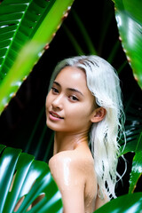 Wet Asian girl with white hair among tropical plants, ai