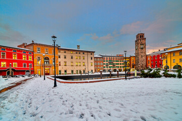 Riva del Garda town and Garda lake in the winter time on a snowy day,Trentino Alto Adige region