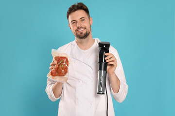 Smiling chef holding sous vide cooker and meat in vacuum pack on light blue background