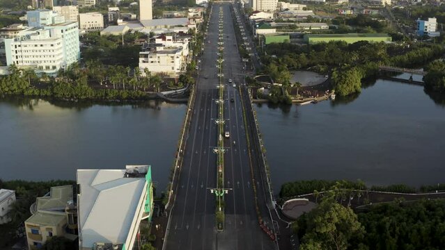 Aerial view of vehicles driving on a large boulevard crossing the lagoon in Iloilo City, on Panay Island in the Philippines.