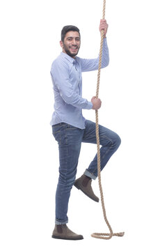 ambitious young man climbing a rope. isolated on a white background.