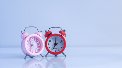 red and pink alarm clocks