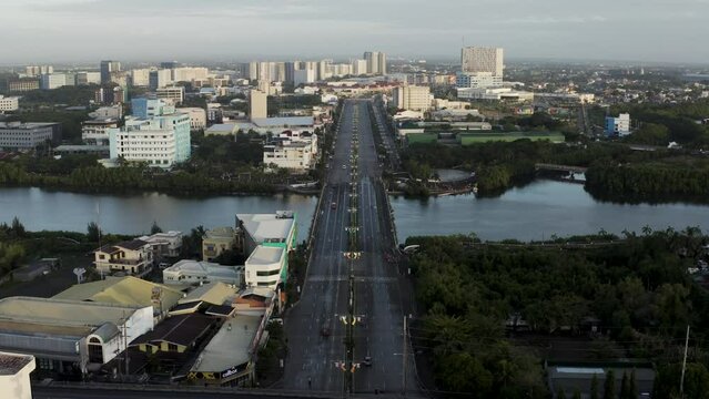 Aerial view of vehicles driving on a large boulevard crossing the lagoon in Iloilo City, on Panay Island in the Philippines.
