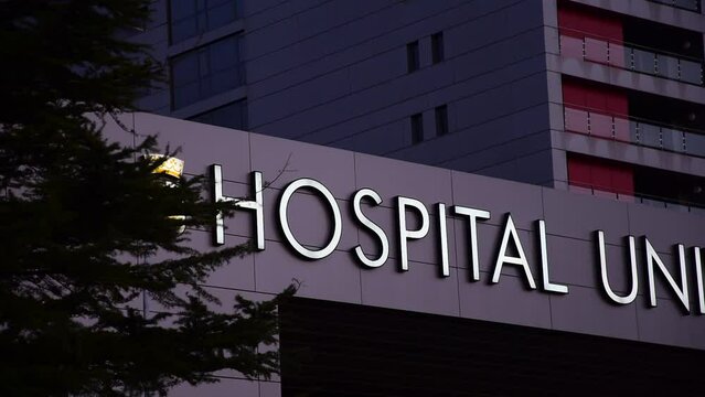 Health Care Hospital Sign And Modern Building Exterior