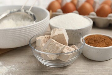 Flour, yeast cake and different ingredients on white wooden table. Making pie