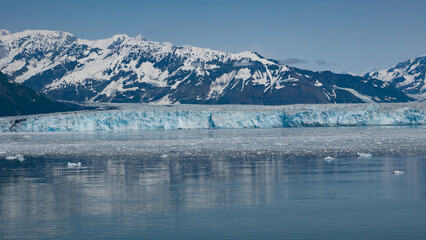 Fototapeta na wymiar Mountain glacier calving and ice in sea ocean water scenery nature. Mountain coast natural landscape