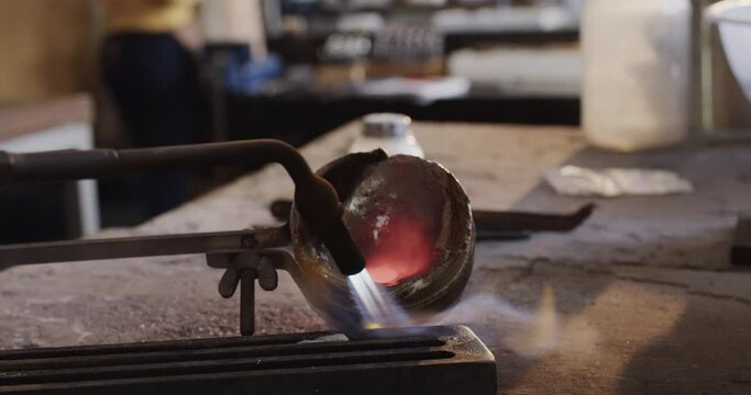 Close up of melting metal with blowtorch in workshop in slow motion