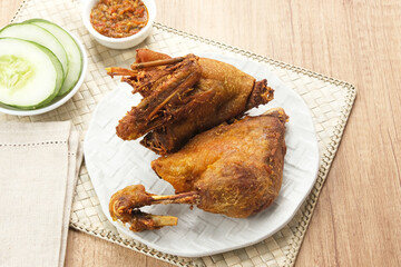 Bebek Goreng, served with chili sauce (sambal) and cucumber. Indonesian food
