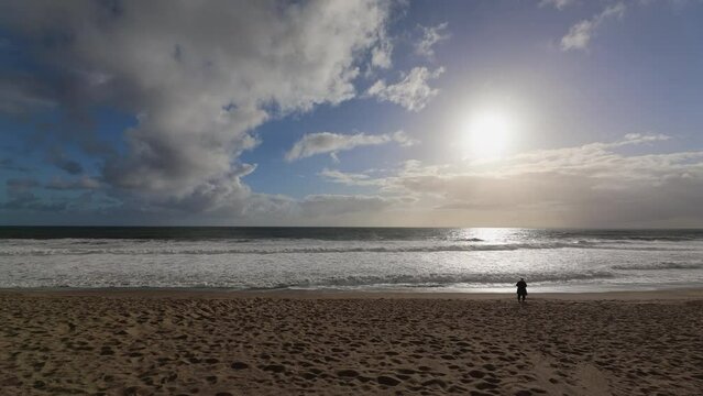 Sunset at Point Dume State beach on a cloudy day, stormy ocean in Malibu, California.
