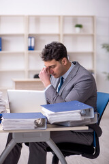 Young male employee working in the office