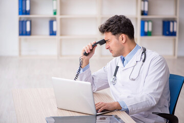 Young male doctor in telemedicine concept