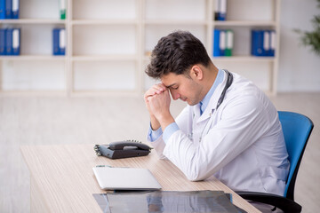 Young male doctor working in the clinic