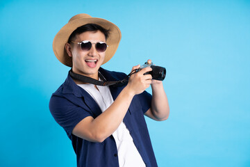 travel asian man portrait, isolated on blue background