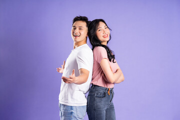Fototapeta premium image of asian couple posing on purple background