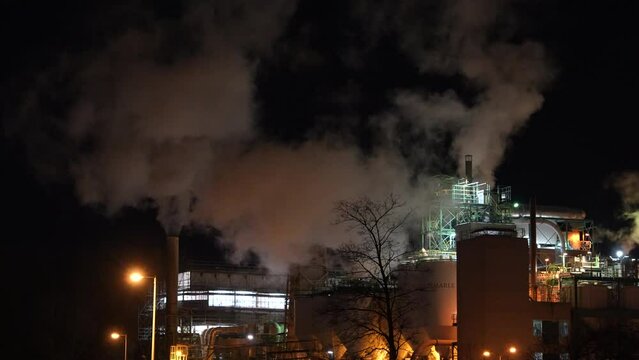 Smoke Coming Out From Chimney Of Albemarle Netherlands BV At Night In Amsterdam, Netherlands. - wide