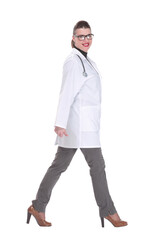 Fototapeta premium Full length portrait of medical doctor woman going sideways