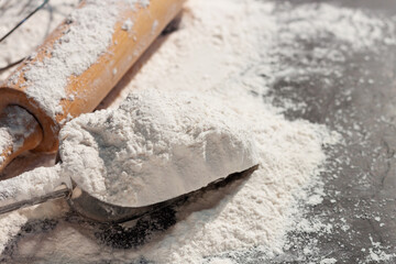 Soft focus close-up, flour ears of wheat barley cooking, bread, and cookies arranged on a wooden table surface in a rustic kitchen, top view.
